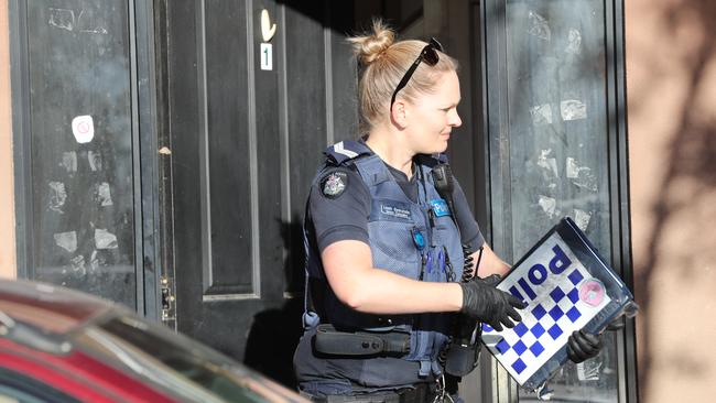 Police at the scene of a home invasion in Albion. Masked thugs have threatened a woman with a knife as she slept in a bedroom with a child at Albion yesterday. Picture: David Crosling