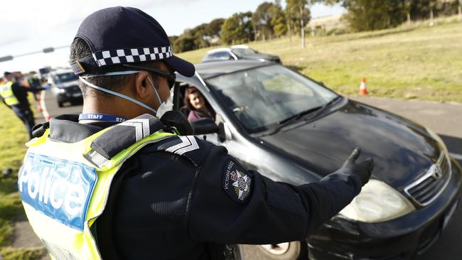 Police perform checks at a roadblock on the Princes Freeway just before Little River. Picture: Getty