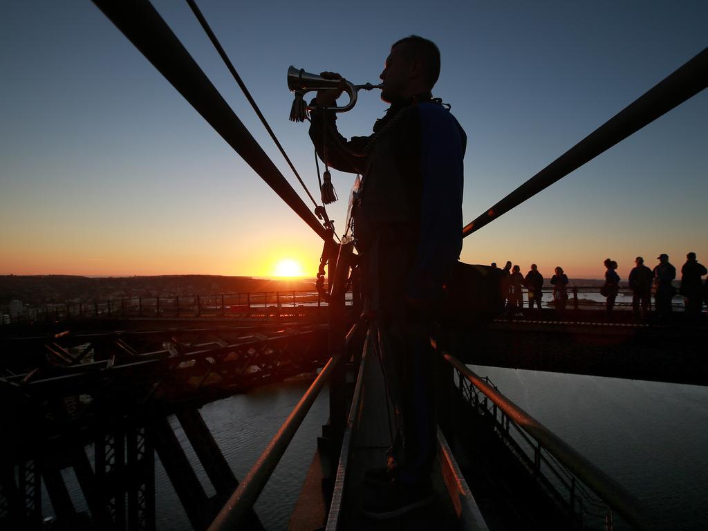 A dawn service was held on the summit of the Sydney Harbour Bridge to commemorate ANZAC Day. Bugler and Leading seaman Marcus Salone plays The Last Post on top of the bridge. Picture: Toby Zerna