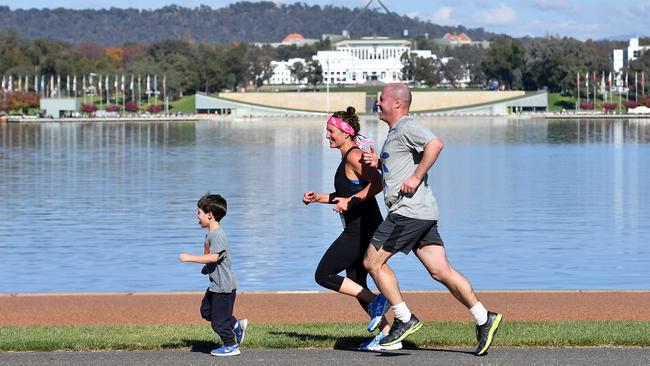 Treasurer Josh Frydenberg runs with wife Amie and son Blake in a mothers' day fun run on May 09, 2021 in Canberra, Australia. Picture: Sam Mooy/Getty Images