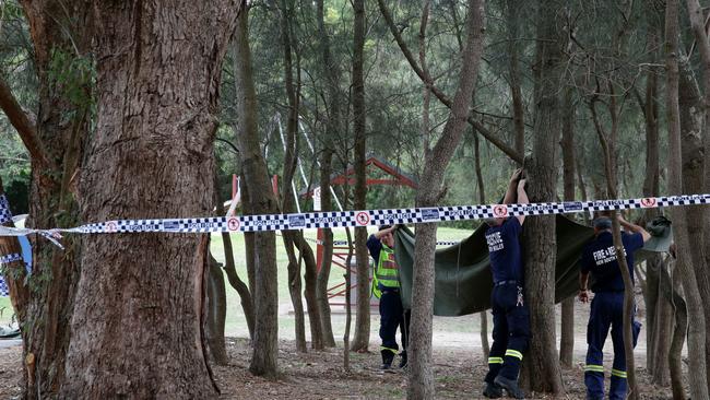 Police place a tarp over the crime scene at Buffalo Creek Reserve Playground in Hunter’s Hill. Picture: Jonathan Ng