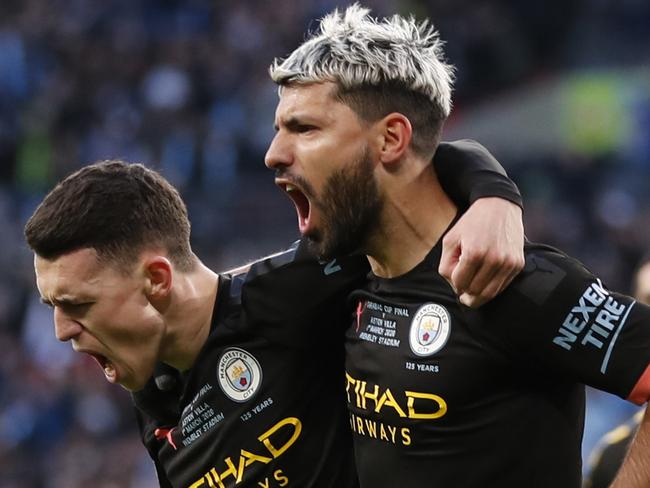 Manchester City's Sergio Aguero, right, celebrates with his teammate Phil Foden after scoring his side's first goal during the League Cup soccer match final between Aston Villa and Manchester City, at Wembley stadium, in London, England, Sunday, March 1, 2020. (AP Photo/Alastair Grant)