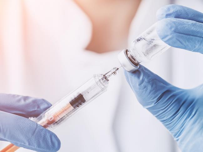 Gold Coast Suns - Coolangatta Medical Centre.injecting injection vaccine vaccination medicine flu man doctor insulin health drug influenza concept - stock image