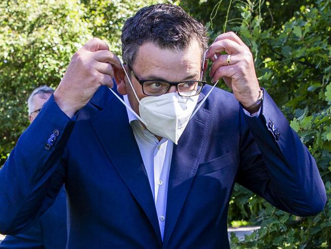 MELBOURNE, AUSTRALIA - NewsWire Photos February 17, 2022: (L-R) Victorian Premier Daniel Andrews puts on a mask after a press conference at Parliament. Picture: NCA NewsWire / Aaron Francis