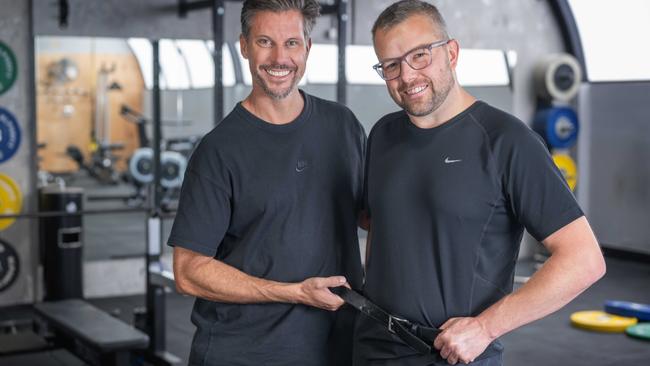 Trainer Sam Wood with Ben Smith who went down a belt size while completing the Health Club program. Picture: Tony Gough