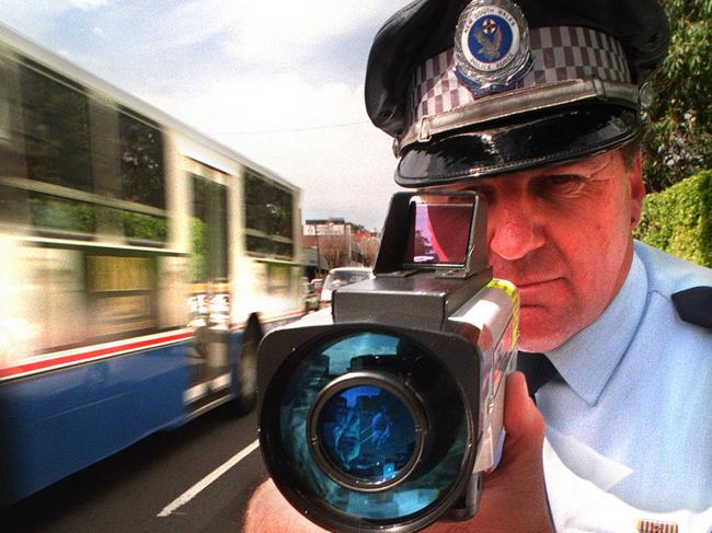 Senior Sergeant Ray Smith uses a radar gun on Parramatta Road, part of the Operation Slow-down campaign in 1997.