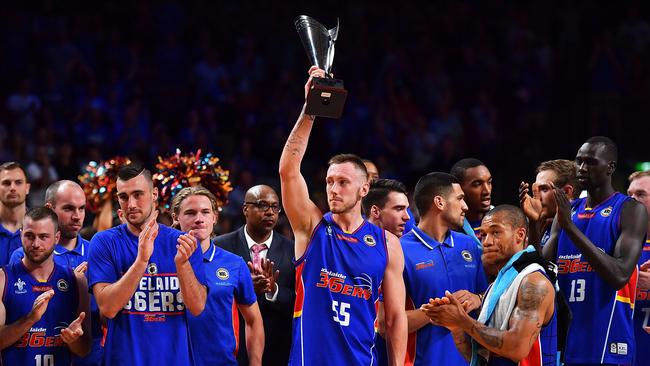 Captain Mitch Creek holds up the Cattalini Cup after the 36ers beat the Wildcats on Thursday night.