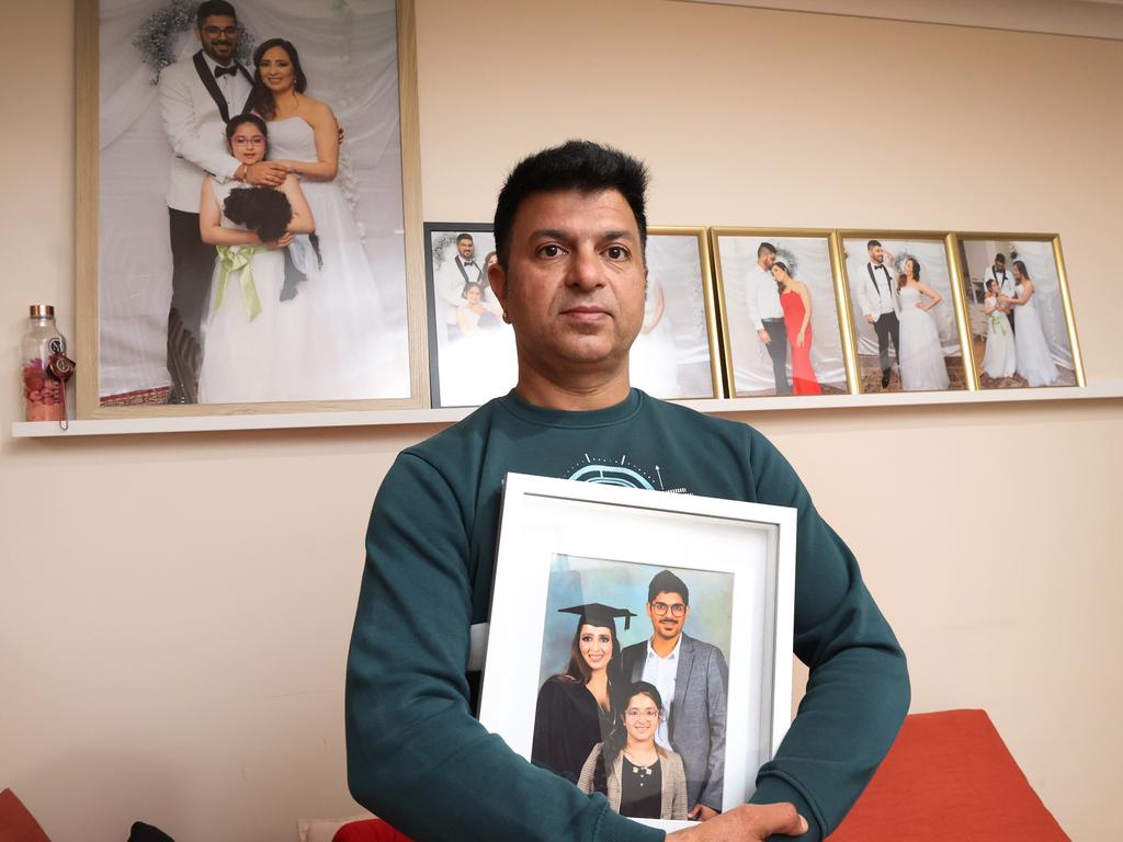 Vikas Sharma holds a photo of his sister. Picture: David Caird