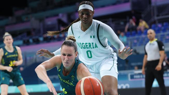Australia's #06 Steph Talbot tumbles below Nigeria's #0 Amy Okonkwo in the women's preliminary round group B basketball match between Nigeria and Australia during the Paris 2024 Olympic Games at the Pierre-Mauroy stadium in Villeneuve-d'Ascq, northern France, on July 29, 2024. (Photo by Thomas COEX / AFP)