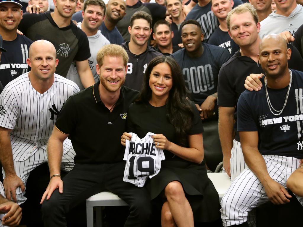 Harry and Meghan with the New York Yankees and their gift to baby Archie. Picture: Getty Images