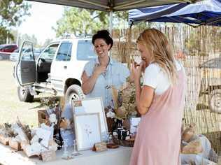 HANDMADE LOVE: Katie May from Wylde Magnolia and an interested customer at a past Sunshine Coast Collective Market. Picture: Contributed