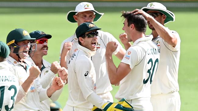 Pat Cummins of Australia and team mates celebrate taking the wicket of Cheteshwar Pujara during day five of the 4th Test Match in the series between Australia and India at The Gabba on January 19, 2021 in Brisbane, Australia. (Photo by Bradley Kanaris/Getty Images)