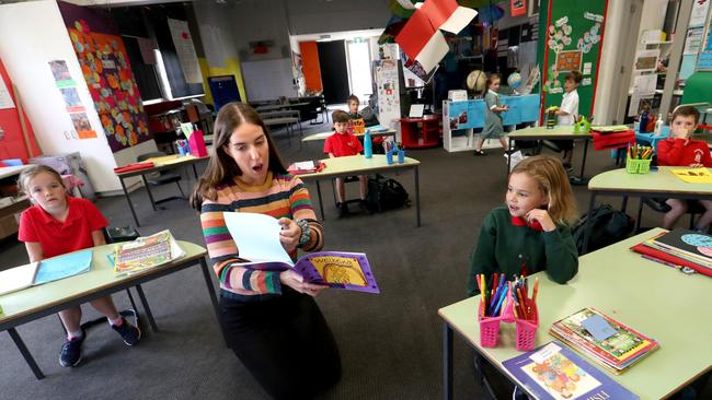 Teacher Georgia Smart with a mixed Prep to Grade 2 class of children of essential services workers at Elsternwick Primary School on Wednesday. Picture: David Geraghty