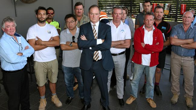 Games Village subcontractors out of pocket after the collapse of site contractor Ware Building met with lawyer James Loel (centre) at the Oxenford Tavern this week to discuss their options. Photo: Steve Holland