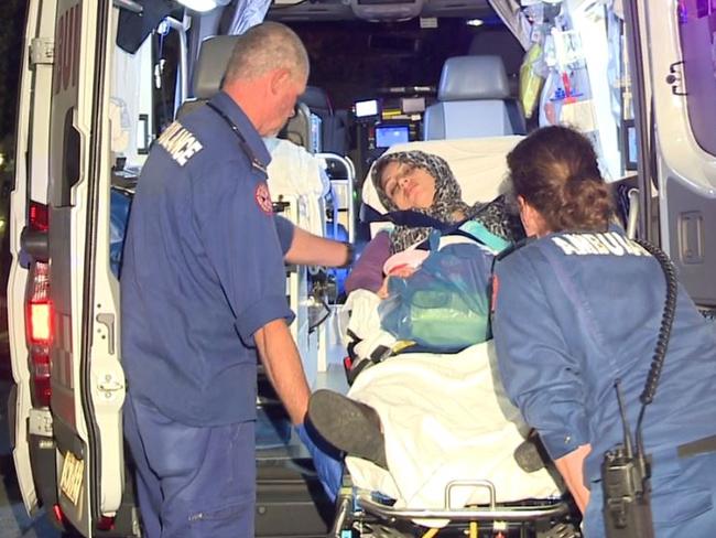 Paramedics place a woman with CO2 poisoning into an abumlance. Picture: Gary Dring