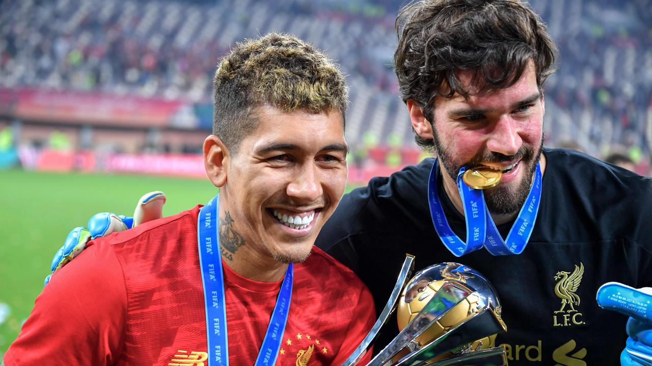 Liverpool's Brazilian forward Roberto Firmino (L) has one of football’s most amazing smiles – and an incredible backstory.