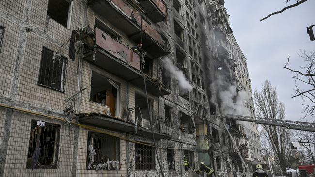 Firefighters search a smouldering apartment building after it was shelled in the northwestern Obolon district. Picture: Aris Messinis / AFP