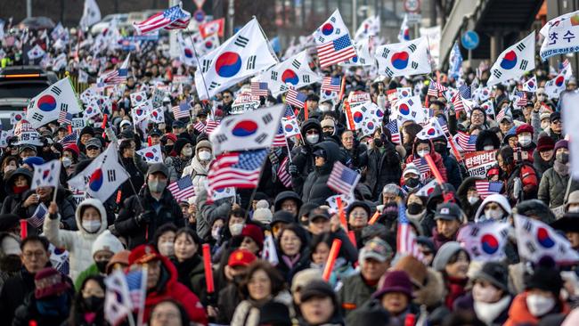 Participants wave US &amp; South Korean flags during a rally to support impeached South Korea's President Yoon Suk Yeol near the presidential residence in Seoul. Picture: AFP.