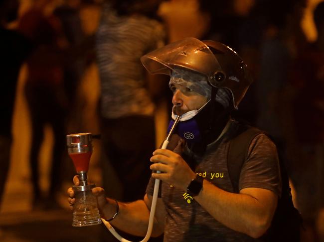 A Lebanese protester smokes a water pipe amid protests in Beirut. Picture: AFP