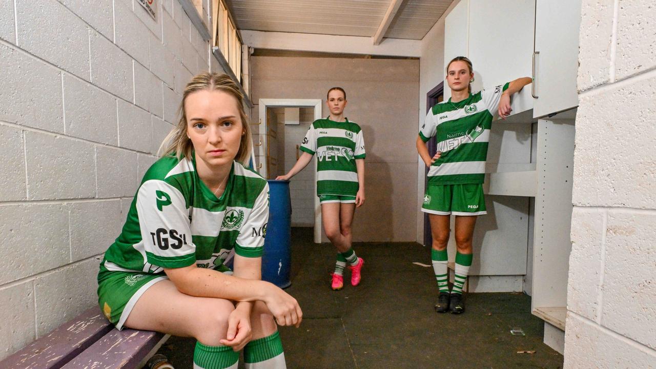 Mercedes Old Collegiate Soccer Club women's captain Madeleine Price, centre, with team mates Ellie Teitzel and Hannah George at their derelict clubrooms in Park 21. Picture: Brenton Edwards