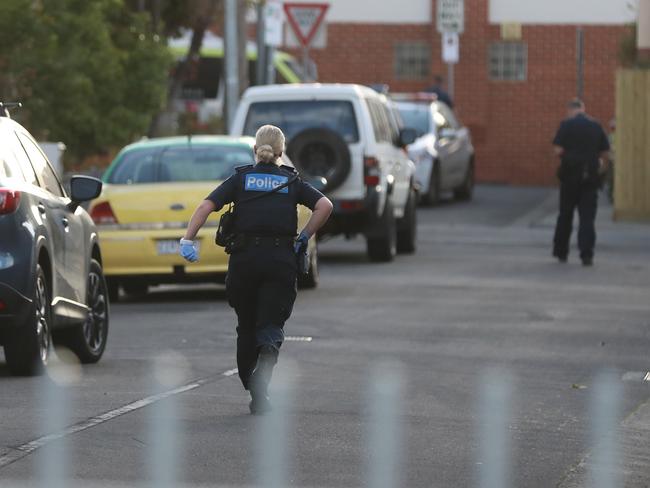 A police officer runs to the scene. Picture: Alex Coppel