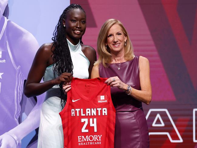 Nyadiew Puoch holds an Atlanta jersey with WNBA commissioner Cathy Engelbert after being selected 12th overall by the Dream in this year’s draft. Picture: Getty Images