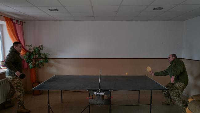 Ukrainian soldiers from the 59th brigade play ping pong near the frontline in Donetsk.