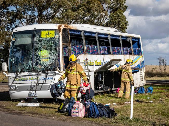 Emergency crews remove students’ belongings from the bus. Picture: Jake Nowakowski