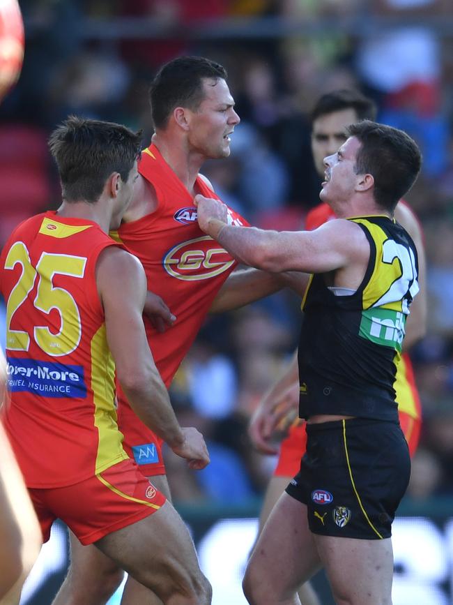 Steven May of the Suns (centre) is grabbed by Jack Higgins of the Tigers during the Round 21 AFL match between the Gold Coast Suns and the Richmond Tigers at Metricon Stadium on the Gold Coast, Saturday, August 11, 2018. Picture: AAP Image/Darren England