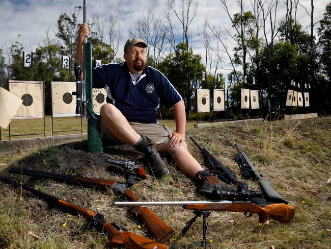 Tasmanian sporting shooter Andrew Judd with part of his collection of guns at the Blue Hills Sporting Shooters Club at Copping. Picture: PETER MATHEW