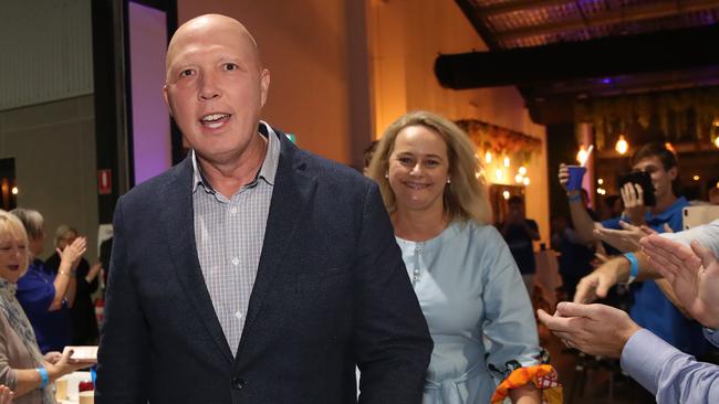 Federal Liberal member for Dickson, Peter Dutton arrives at his party in Brendale alongside wife Kirilly. Picture: Zak Simmonds