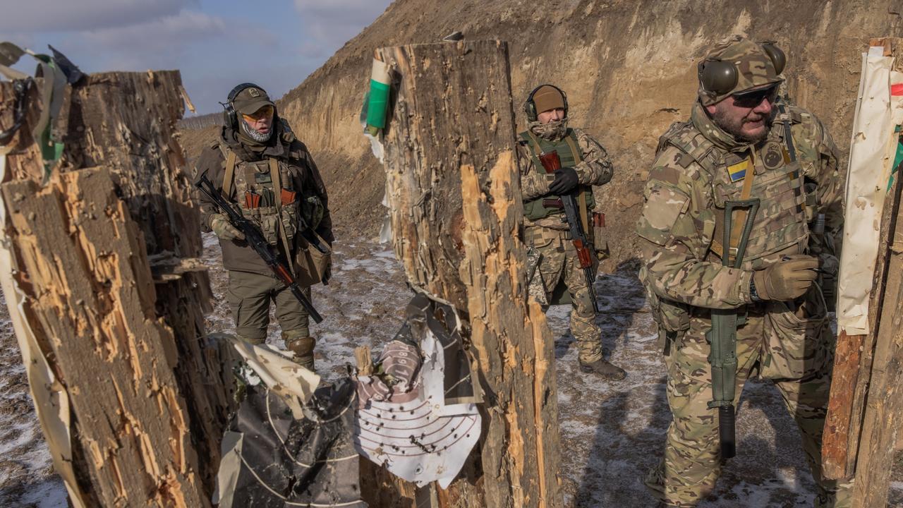 Ukrainian members of the Territorial Defense Forces check targets after shooting during training. Picture: Getty