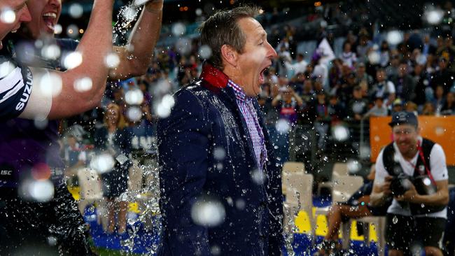 Coach Craig Bellamy is soaked after winning the 2017 NRL Grand Final.