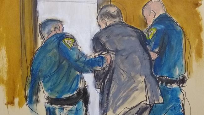 In this courtroom sketch, Harvey Weinstein, centre, is led out of Manhattan Supreme Court by court officers after a jury convicted him of rape and sexual assault. Picture: AP