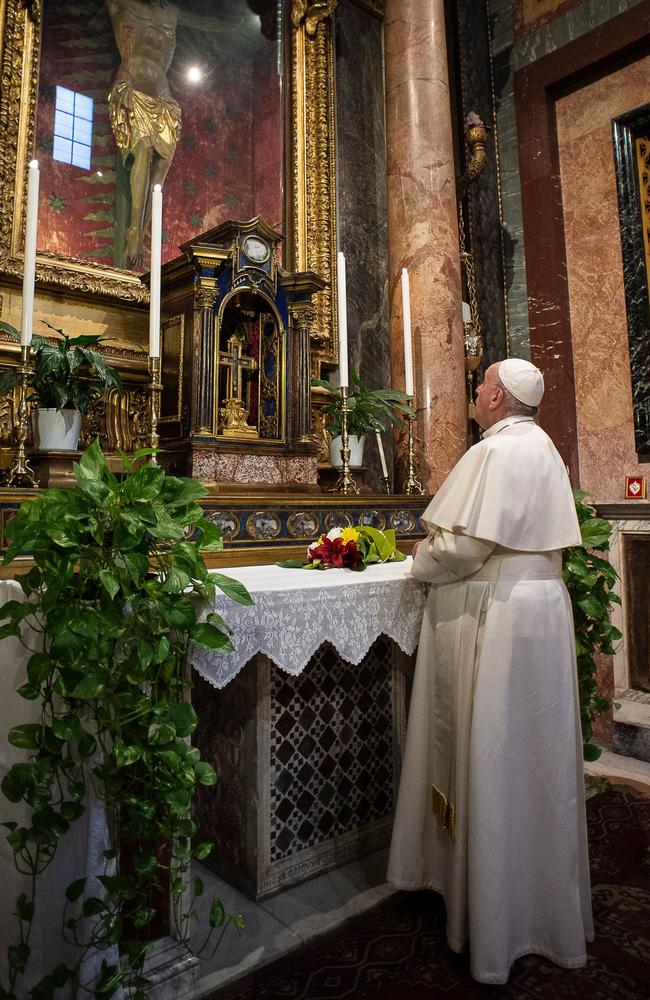 Pope Francis prays in S. Marcello al Corso church, where there is a miraculous crucifix that in 1552 was carried in a procession around Rome to stop the great plague. Picture: Vatican Media/AFP