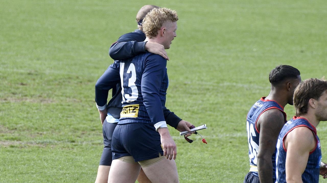 Melbourne coach Simon Goodwin embraces Clayton Oliver at training on Wednesday before the midfielder suffered a dislocated finger on the track. Picture: Andrew Henshaw