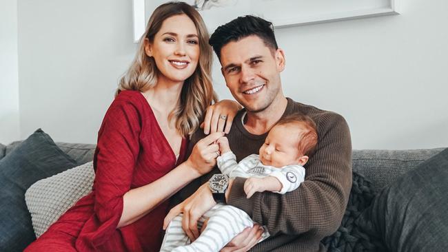 TV star Nikki Phillips and husband Dane Rumble enjoy a couch moment with baby Jett.