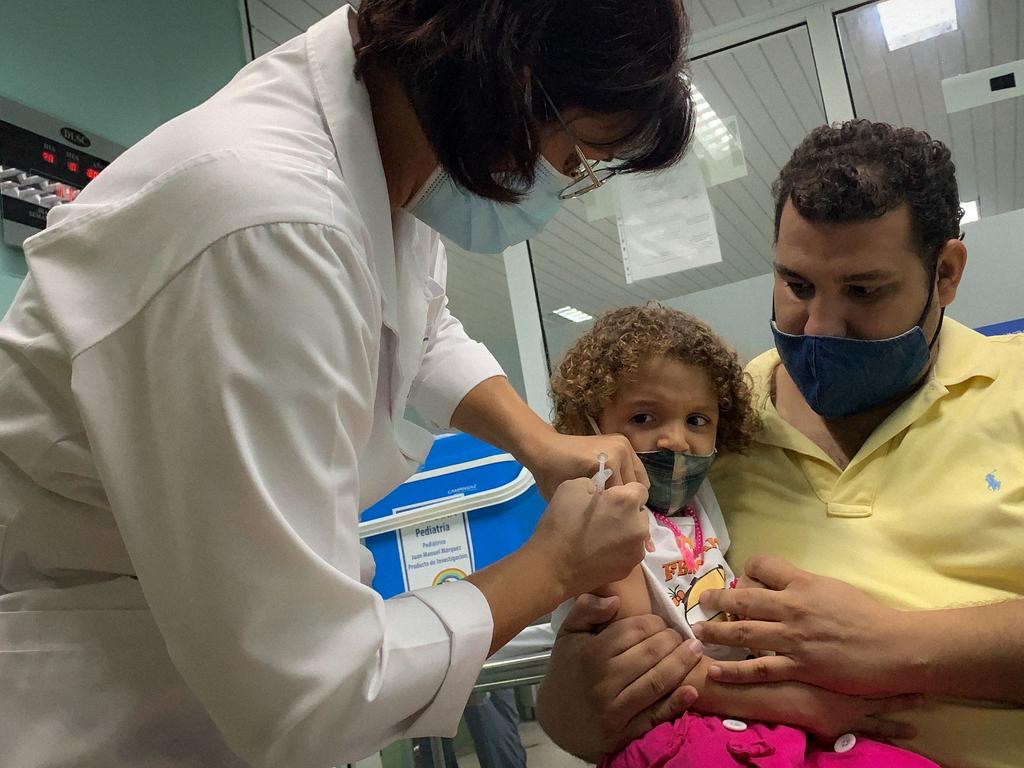 Pedro Montano holds his daughter Roxana, 3, as she is inoculated against Covid-19 in Cuba, the first nation to give the jab to kids as young as 2. Picture: Adalberto Roque/ AFP