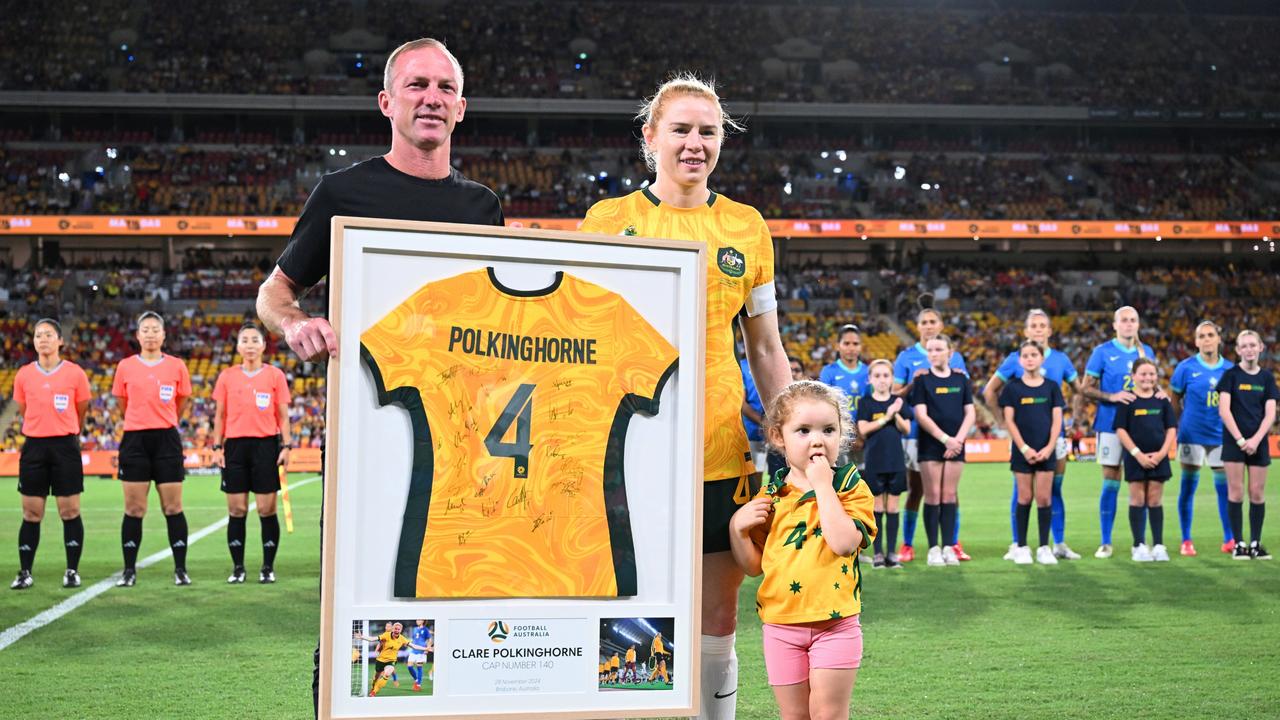 Darren Lockyer presenting a framed jersey to Polkinghorne. (Photo by Bradley Kanaris/Getty Images)