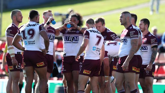 Manly players stand dejected during the round 14 NRL match between the Newcastle Knights and the Manly Sea Eagles at McDonald Jones Stadium.