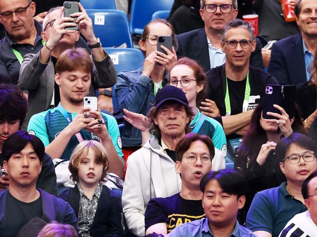 British singer Sir Mick Jagger (in a cap) of The Rolling Stones attends fencing competition during the Paris 2024 Olympic Games at the Grand Palais in Paris, on July 27, 2024. (Photo by Franck FIFE / AFP)