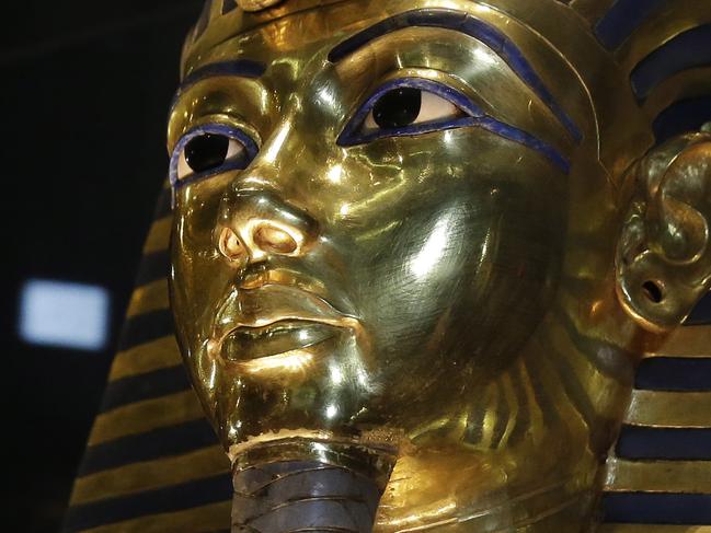 FILE - In this Saturday, Jan. 24, 2015, file photo, the gold mask of King Tutankhamun is seen in its glass case during a press tour, in the Egyptian Museum near Tahrir Square, Cairo, Egypt. Egypt’s antiquities ministry said on Thursday, Nov. 26, 2015 that exploration has begun inside King Tutankhamun’s 3,300 year-old tomb, in the search for alleged hidden chambers, one of which may include Queen Nefertiti, according to a new theory. (AP Photo/Hassan Ammar, File)