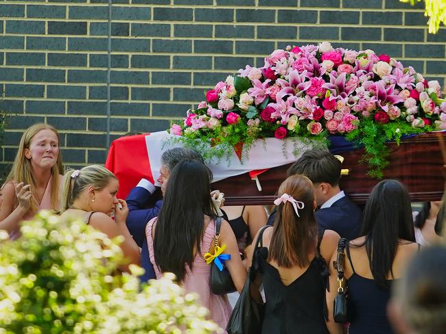 Holly Morton-Bowles’ coffin was covered in red and pink flowers. Picture: NewsWire / Luis Enrique Ascui