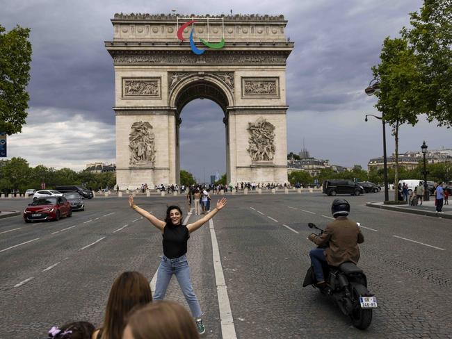 PARIS, FRANCE - JULY 15: Visitor poses for a photo near the Arc de Triomphe on July 15, 2024 in Paris, France. (Photo by Maja Hitij/Getty Images)