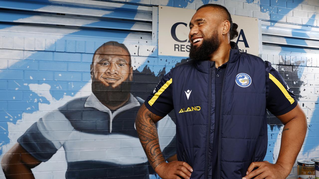 Parramatta Eels prop Junior Paulo with the mural of himself at his junior club, Cabramatta Leagues Club. Taubmans are donating a series of footy club rescue packages, which includes the delivery of people and paint to make clubs look fresher. Picture: Jonathan Ng