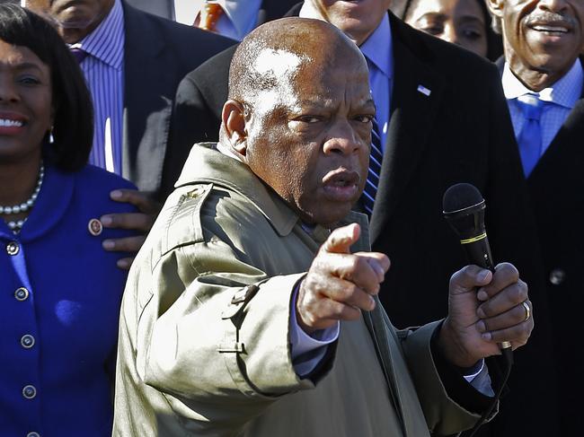 U.S. Rep. John Lewis, D-Ga., points to where he and others were beaten 48 years ago when they tried to cross the Edmund Pettus Bridge during a civil rights march in Selma, Ala., Sunday, March 3, 2013. At rear is Vice President Joe Biden. At left is U/S. Rep. Terri Sewell, D-Ala., Jesse Jackson is second from left. (AP Photo/Dave Martin)