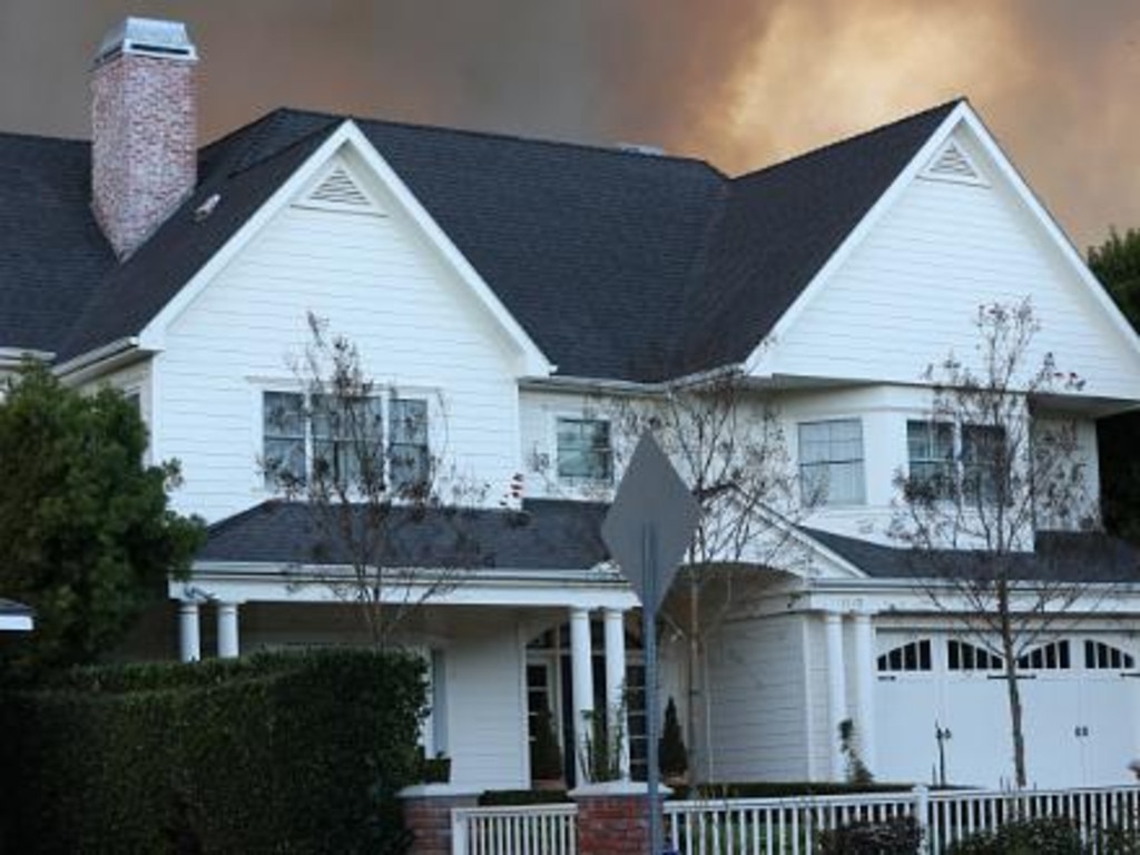 The Pacific Palisades home owned by John Goodman seen with smoke behind as the fire approached. Picture: APEX / MEGA