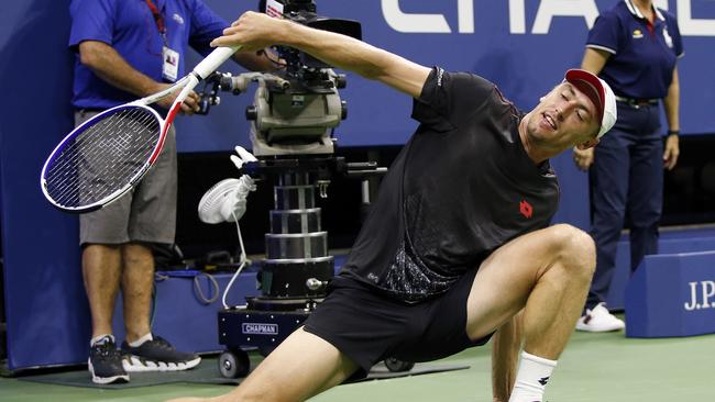 John Millman loses his footing after returning a shot to Roger Federer during the fourth round of the US Open tennis tournament in New York in 2018. Picture: AP Photo/Jason DeCrow.