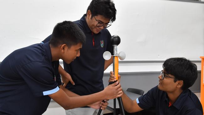 Darwin High School students Monishi Rangchak Tripura, Pothik Vincent Mondol, and Mohammad Niyaz Hasan have devised a strategy to cool rooms cheaply through apparent temperature optimisation. Picture: Sierra Haigh