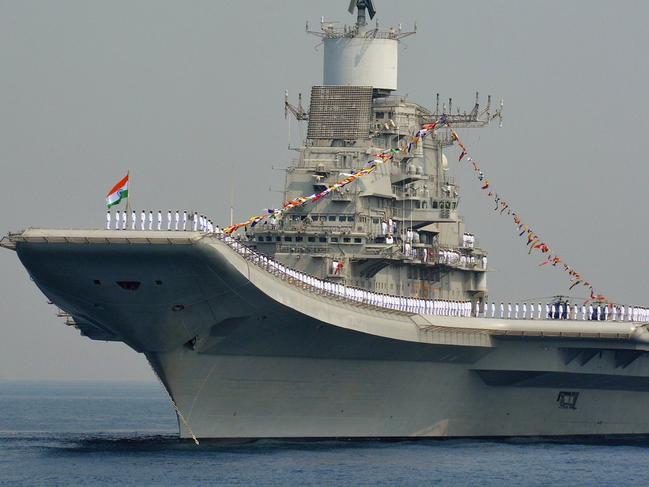 Indian Navy personnel stand on the INS Vikramaditya, a modified Kiev-class aircraft carrier, during the International Fleet Review in Visakhapatnam on February 6, 2016. India kicked off a major display of maritime might, with ships from 50 navies converging on the country's east coast, as New Delhi seeks to boost its leadership in the region. Ninety ships including from the US, French, British and Chinese navies are taking part in the international fleet review in the Bay of Bengal -- a ceremonial inspection and parade of boats and crews. AFP PHOTO